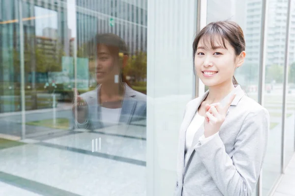 Young business woman walking in business district