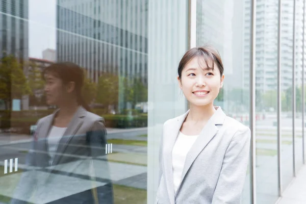 Young business woman walking in business district