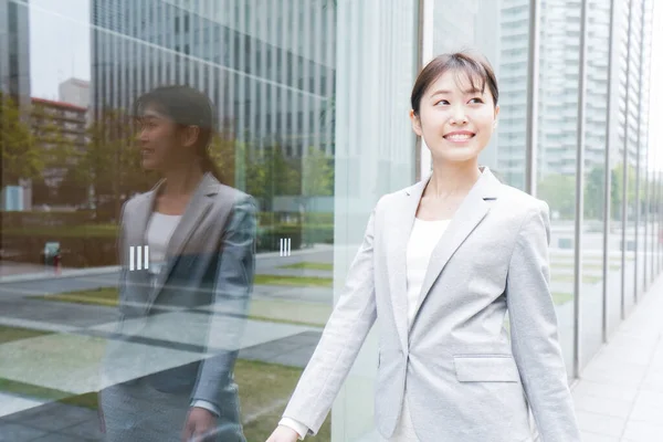 Young business woman walking in business district