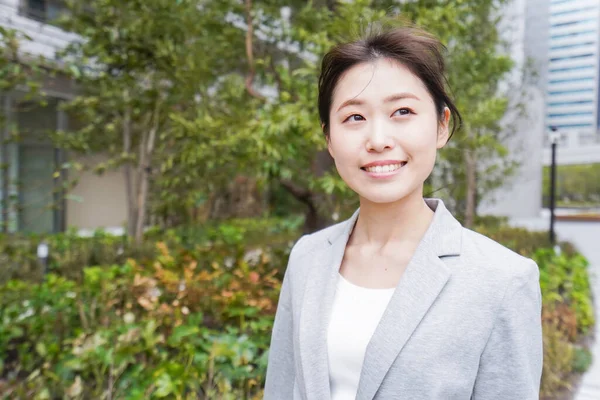 Young business woman walking in business district