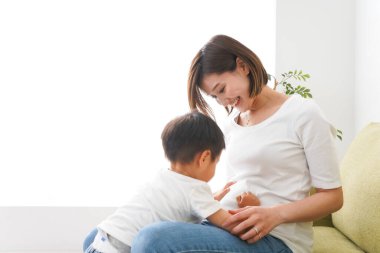 Çocuklar ve anne evde oynuyorlar.