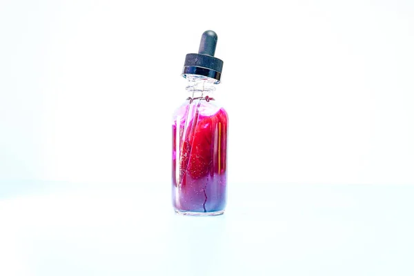 Frasco de vidro com tinta roxa sobre fundo branco — Fotografia de Stock