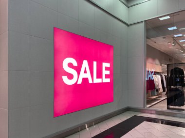 Big pink ad, poster with the inscription - Sale. On the gray wall. For women. There are big discounts in the store. No people clipart