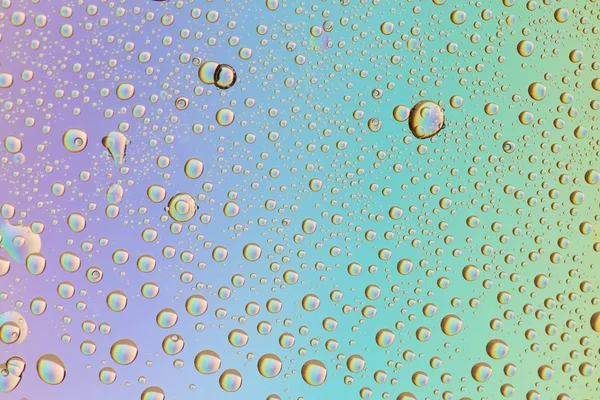 Macro iniezione di goccioline liquide con riflesso. colore di sfondo con texture gocce d'acqua. colore del gradiente — Foto Stock