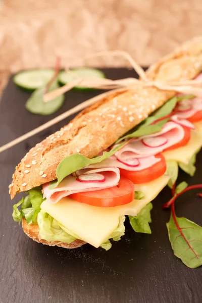 sandviç Fransız baget, peynir, jambon, domates, turp, marul portre. ev yapımı yemek. gevrek ekmek