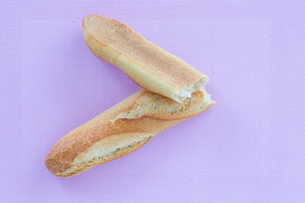 Baguette on a pink background. view from above — Stock Photo, Image