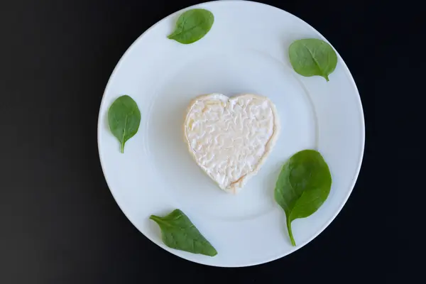 Jahody a sýr ve tvaru srdce a špenát — Stock fotografie