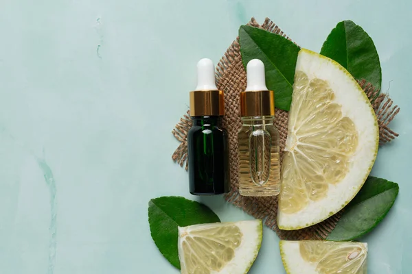 grapefruit oil serum bottle put on green light background