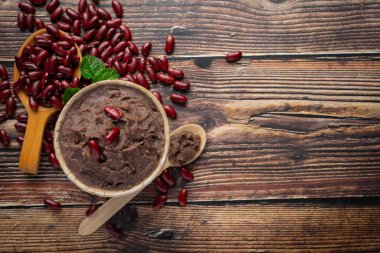sweet red bean paste in white bowl place on wooden floor