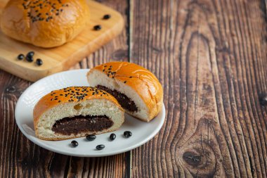 baked black bean paste buns put on white bowl