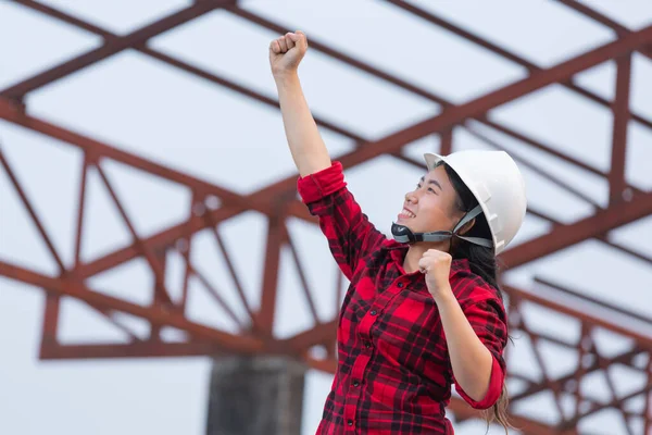 Workers woman holding a helmet in hand on the eve of holidays, Happy Holidays, Labor Day