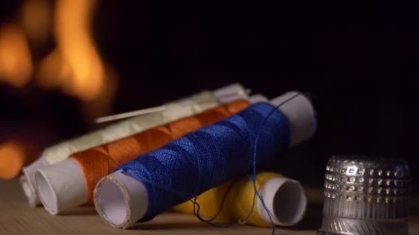 Coils Colored Thread Thimble Rotate Background Fireplace Flame Close Shooting — Stock Video