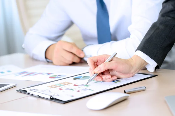 Business colleagues working and analyzing financial figures on a graphs — Stock Photo, Image