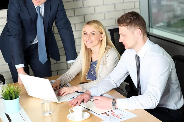 Affärskollegor arbetar tillsammans och analysera finansiella siffror på en bärbar dator — Stockfoto