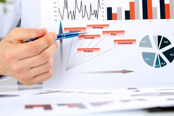 Business man  analyzing financial figures on a graphs — Stock Photo, Image