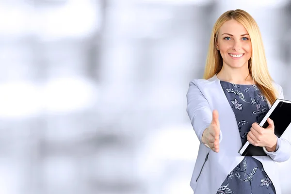Business woman giving a hand/ handshake  in the office — Stock Photo, Image