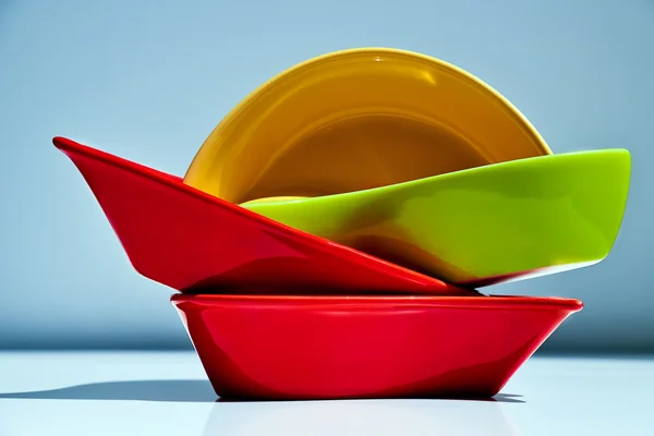 Stack of multicolored ceramic dishes  on white background — Stock Photo, Image