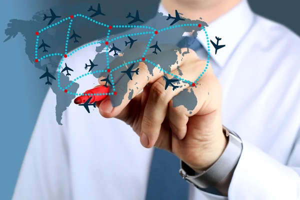 Young business man touching  an airplane routes on world map. — Stock Photo, Image