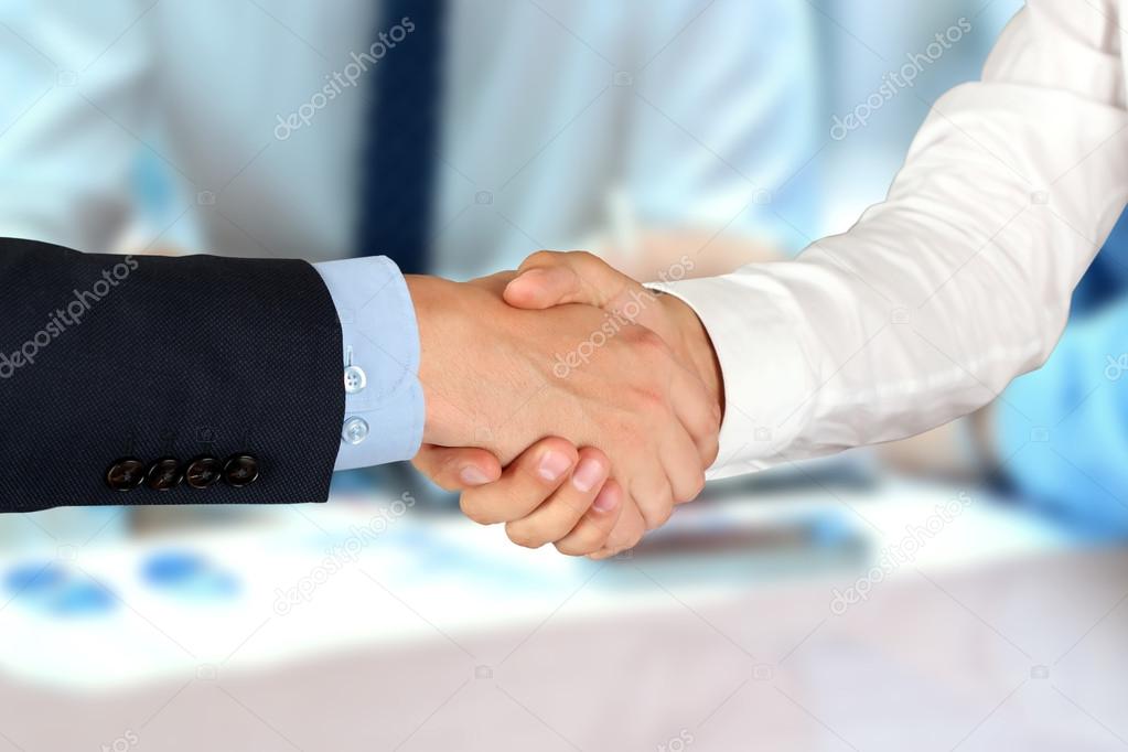 Close-up image of a firm handshake  between two colleagues in of