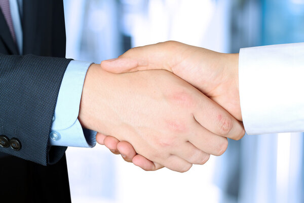 Close-up image of a firm handshake  between two colleagues outsi