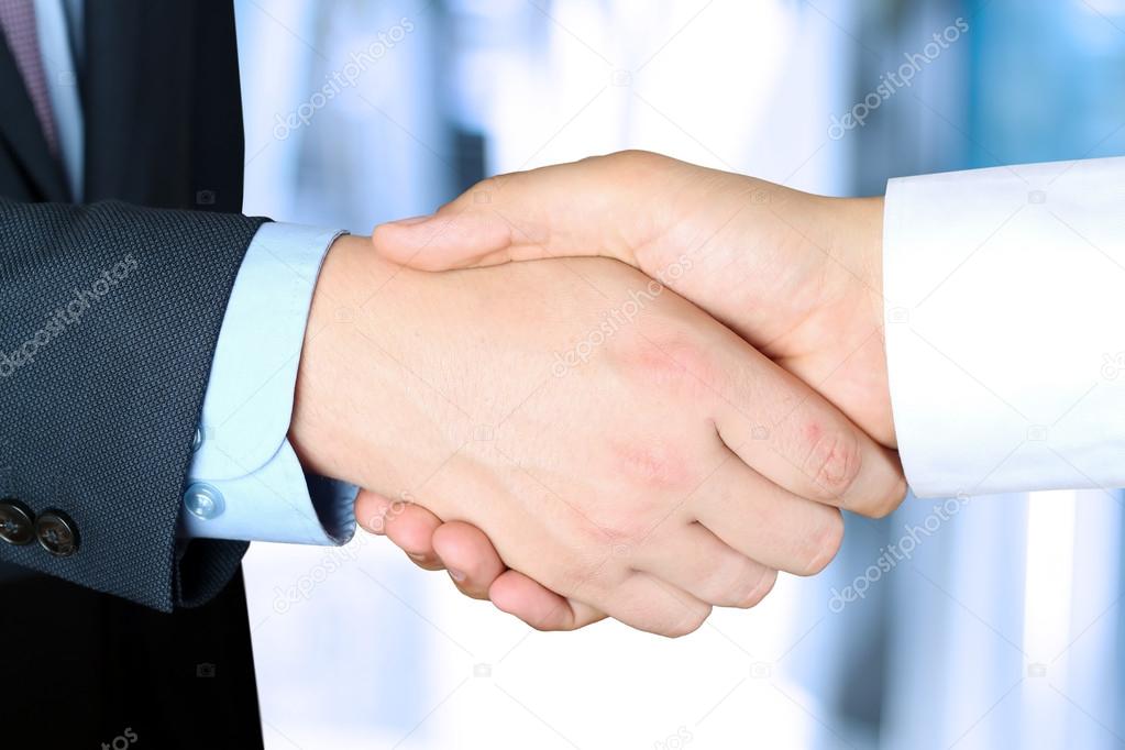 Close-up image of a firm handshake  between two colleagues outsi