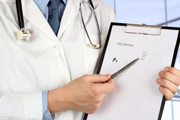 Young medical doctor   holding  an empty form of  prescription — Stock Photo, Image