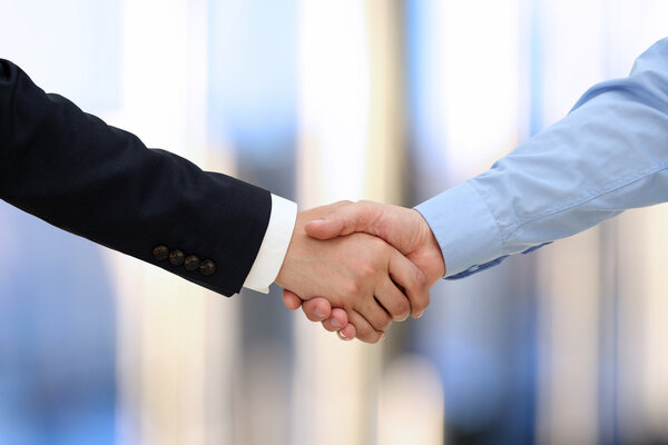 Close-up image of a firm handshake  between two colleagues in of