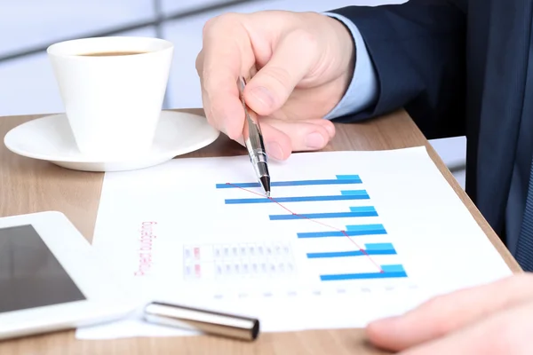 Modern business man  doing business, graphs and charts behind — Stock Photo, Image