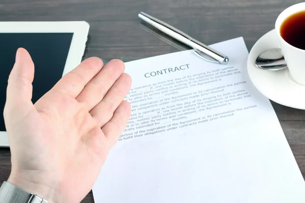 Man sitting in a table showing, offering  a contract and where t — Stock Photo, Image