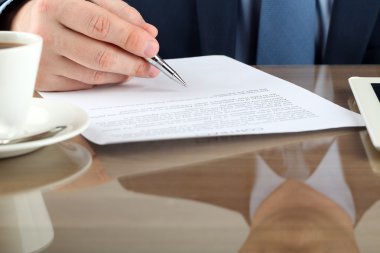 İş adamı kontrat imzalıyor, iş sözleşmesi detayları.