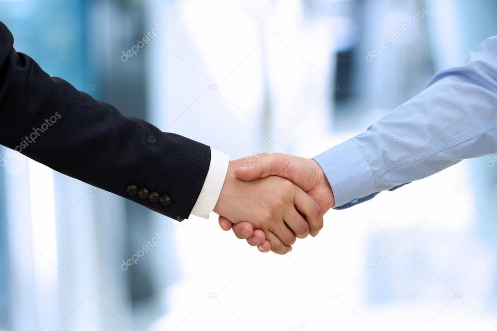 Close-up image of a firm handshake  between two colleagues in of