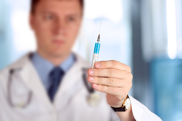 Young Doctor with syringe in his hand
