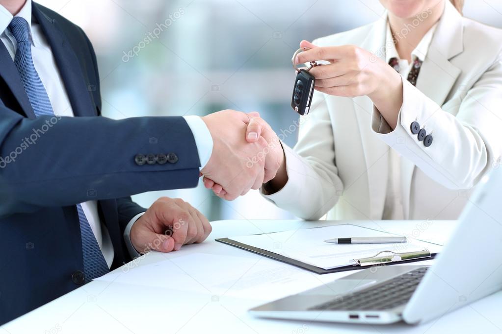 Close-up image of a firm handshake  between two colleagues in office.