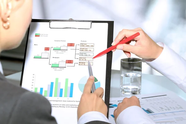 Business colleagues working and analyzing financial figures on a graphs — Stock Photo, Image