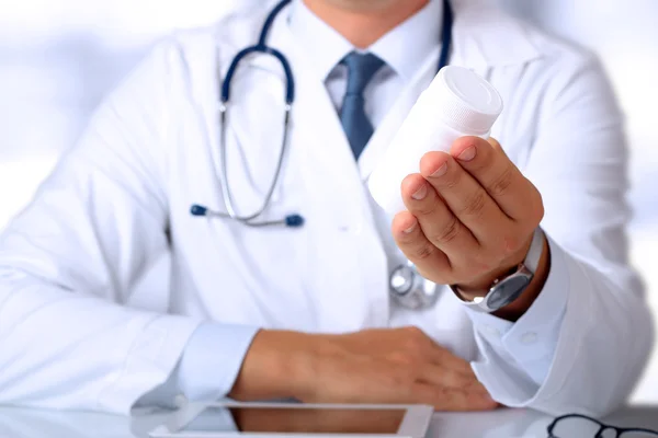 Cropped image of doctor showing a bottle of pills to the patient — Stock Photo, Image