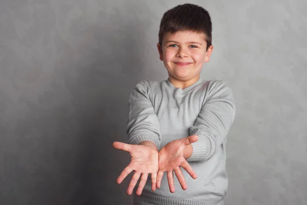 바탕에 아이의 모습이 손가락으로 즐겁고 몸짓을 보인다 소년의 상징적 동작을 — 스톡 사진