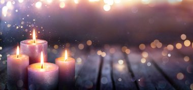 Abstract Advent - Four Purple Candles With Soft Blurry Lights And Glittering On Flames clipart