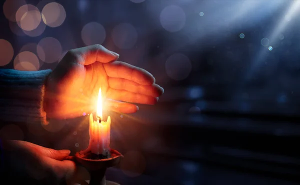Defocused Hope Concept Hands Holding Candle Shining Flame Blurry Lights — стоковое фото