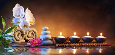 Spa Massage Stones With Candles And Towels On Bamboo Mat - Meditation Concept