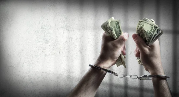 Arrest for corruption - man handcuffed holding dollars — Stock Photo, Image