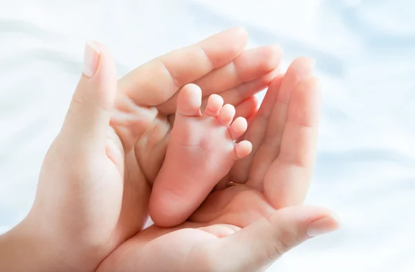 Baby foot in mother hands — Stock Photo, Image