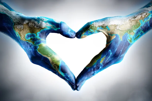 Earth's day celebration - hands shaped heart with world map — Stock Photo, Image