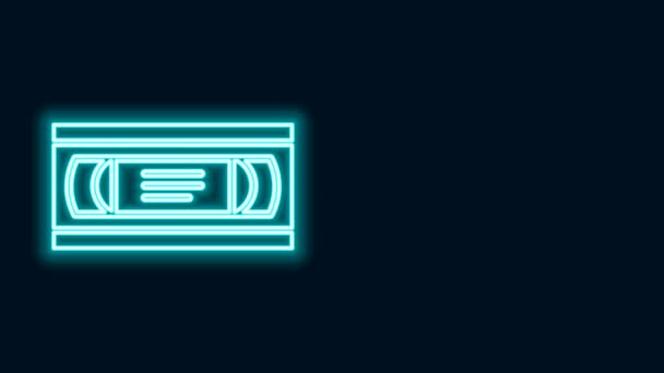 Glowing neon line VHS video cassette tape icon isolated on black background. 4K Video motion graphic animation — Stock Video
