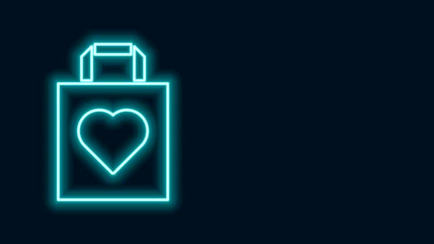 Zářící neonová linka Nákupní taška s ikonou srdce izolované na černém pozadí. Obchod s taškami miluje jako ikonu srdce. Symbol Valentýna. Grafická animace pohybu videa 4K — Stock video