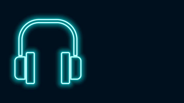 Zářící neonová linka Sluchátka ikona izolované na černém pozadí. Sluchátka. Koncepce poslechu hudby, služeb, komunikace a operátora. Grafická animace pohybu videa 4K — Stock video
