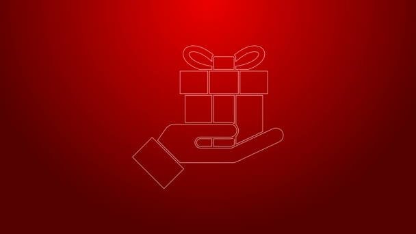 녹색 라인 선물 상자, 손에 아이콘을 들고 붉은 배경에서 분리. 메리 크리스마스, 새해 복 많이 받으세요. 4K 비디오 모션 그래픽 애니메이션 — 비디오
