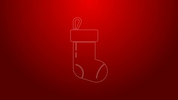 Green line Christmas stocking icon isolated on red background. Merry Christmas and Happy New Year. 4K Video motion graphic animation — Stock Video