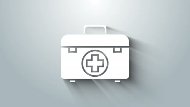 Λευκό κουτί πρώτων βοηθειών απομονωμένο σε γκρι φόντο. Ιατρικό κουτί με σταυρό. Ιατρικός εξοπλισμός για έκτακτη ανάγκη. Υγιεινή έννοια. 4K Γραφική κίνηση κίνησης βίντεο — Αρχείο Βίντεο