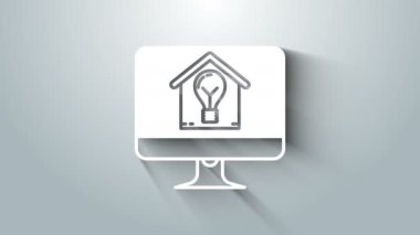 Akıllı ev ve ampul ikonuna sahip beyaz bilgisayar monitörü gri arkaplanda izole edilmiş. 4K Video hareketli grafik canlandırması