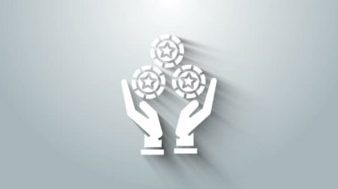 Beyaz El 'in elinde gri arka planda izole edilmiş bir kumarhane fişi simgesi var. Kumarhane kumarı. 4K Video hareketli grafik canlandırması